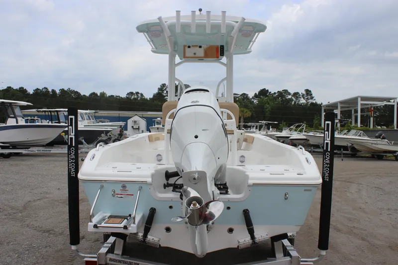 Slide: The Image of 2025 Sea Pro 202 CC boat, rear view, on trailer, in a marina setting. - 3