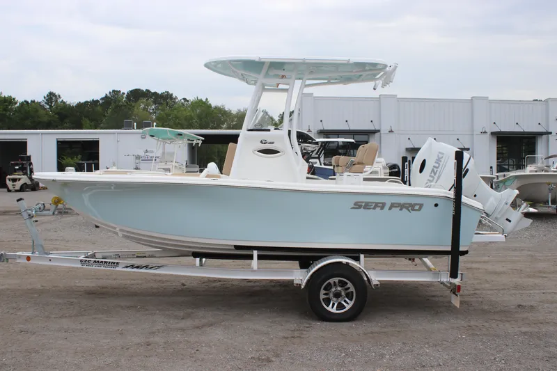 Slide: The Image of 2025 Sea Pro 202 CC boat on trailer, light blue hull, parked outdoors. - 4