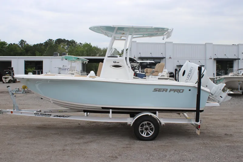 Slide: The Image of 2025 Sea Pro 202 CC boat on trailer, light blue hull, parked outdoors. - 5