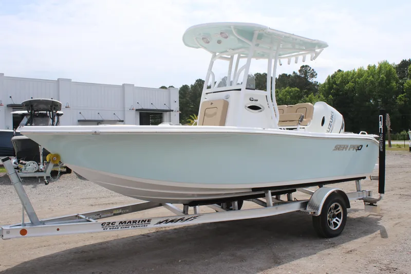 Slide: The Image of 2025 Sea Pro 202 CC boat on trailer, light blue hull, outdoor setting. - 6