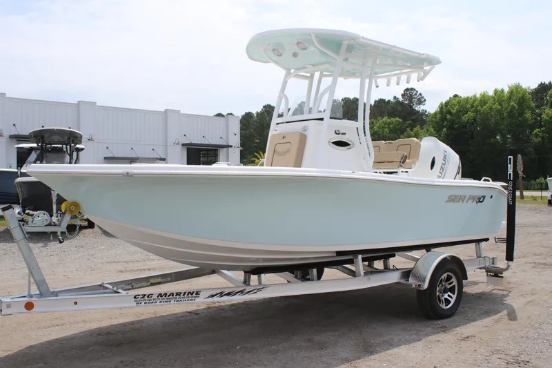Slide: The Image of 2025 Sea Pro 202 CC boat on trailer, light blue hull, outdoor setting. - 7