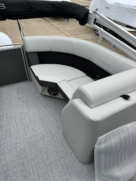 Slide: The Image of 2025 Harris Cruiser 210 boat interior with sleek, modern seating and gray flooring. - 7