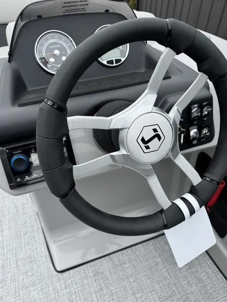 Slide: The Image of Steering wheel of 2025 Harris Cruiser 210 boat with dashboard controls. - 8