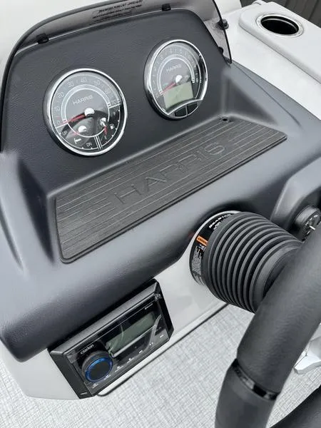 Slide: The Image of 2025 Harris Cruiser 210 dashboard with gauges and steering wheel. - 9
