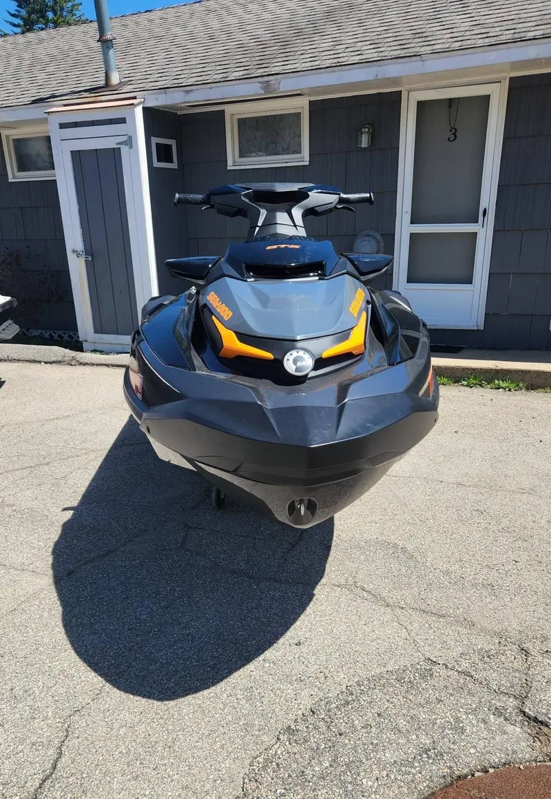 Slide: The Image of 2023 Sea-Doo GTX 170 SS iDF jet ski parked in front of a house. - 2