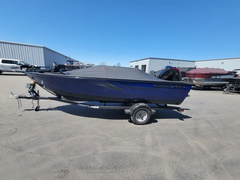 Slide: The Image of 2023 Crestliner 1750 Fish Hawk SE SC boat on trailer, covered, in outdoor lot. - 10