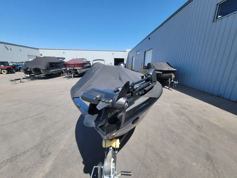 Slide: The Image of 2023 Crestliner 1750 Fish Hawk SE SC boat covered, parked outside a warehouse. - 11