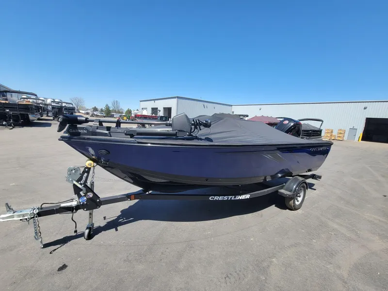 Slide: The Image of 2023 Crestliner 1750 Fish Hawk SE SC boat on trailer, parked outdoors. - 12