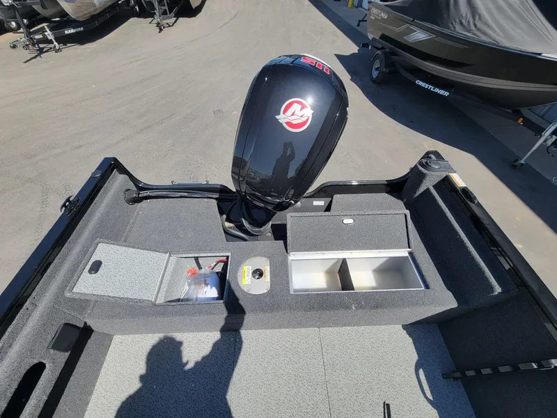 Slide: The Image of 2023 Crestliner 1750 Fish Hawk SE SC boat interior with storage compartments and motor. - 17