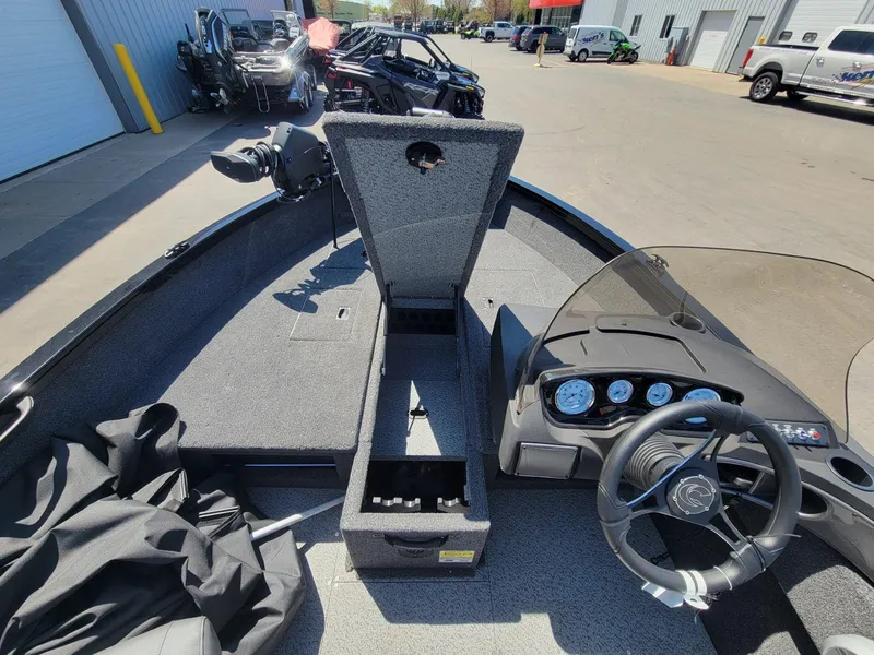 Slide: The Image of 2023 Crestliner 1750 Fish Hawk SE SC boat interior with open storage and dashboard view. - 20