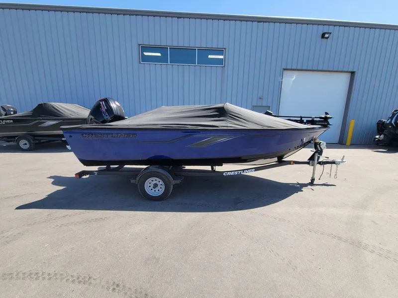 Slide: The Image of 2023 Crestliner 1750 Fish Hawk SE SC boat with cover on trailer, parked outside. - 9