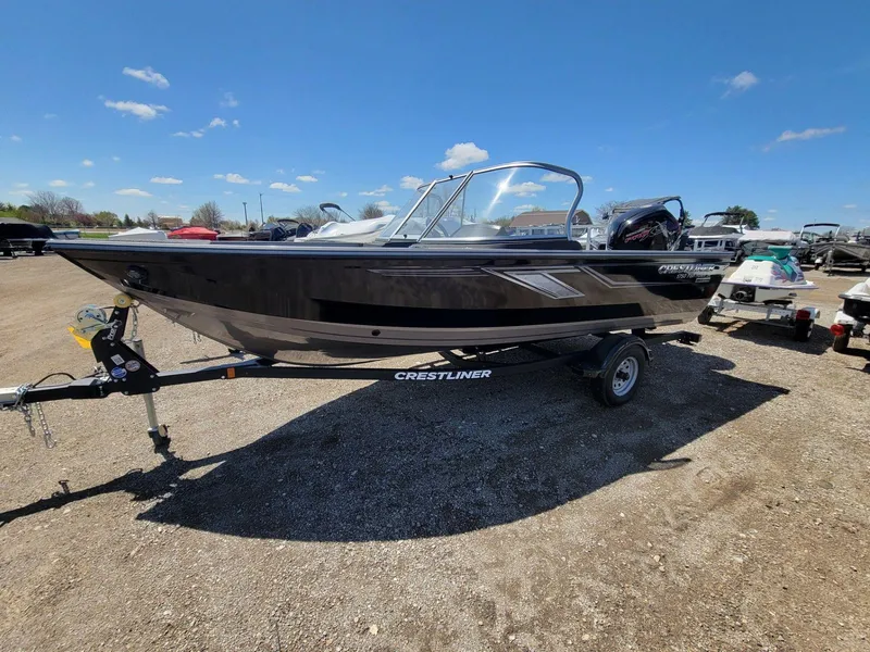 Slide: The Image of 2023 Crestliner 1750 Fish Hawk SE WT boat on trailer under clear blue sky. - 1