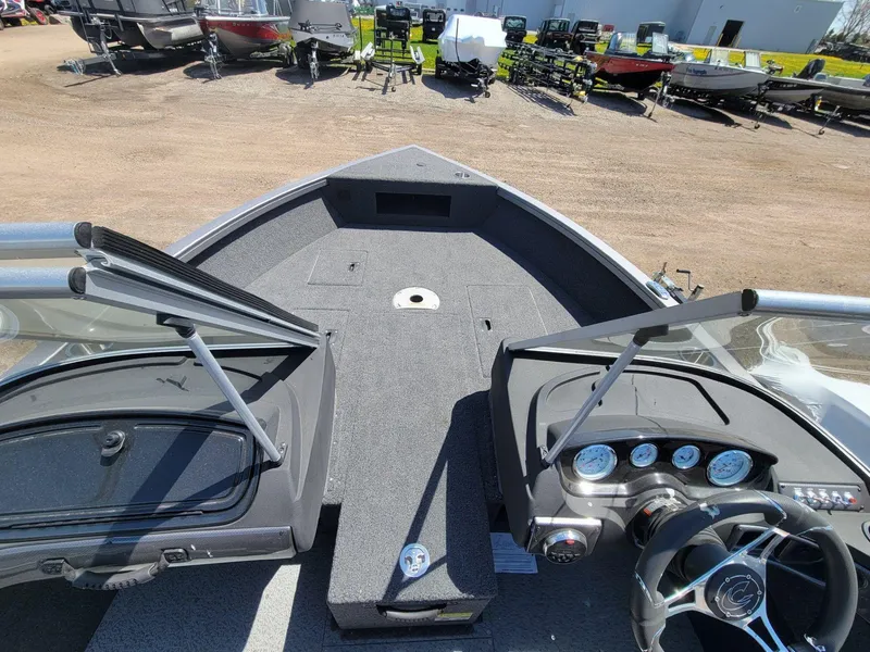 Slide: The Image of 2023 Crestliner 1750 Fish Hawk SE WT boat interior with dashboard and open deck view. - 11