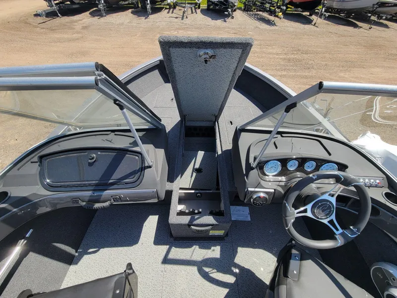 Slide: The Image of 2023 Crestliner 1750 Fish Hawk SE WT boat interior with open storage and dashboard view. - 12