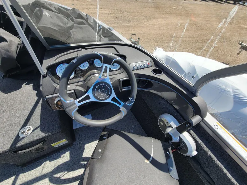 Slide: The Image of 2023 Crestliner 1750 Fish Hawk SE WT boat cockpit with steering wheel and dashboard controls. - 14