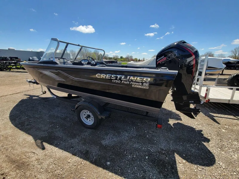Slide: The Image of 2023 Crestliner 1750 Fish Hawk SE WT boat on trailer under clear blue sky. - 2