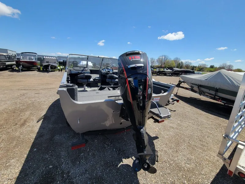 Slide: The Image of 2023 Crestliner 1750 Fish Hawk SE WT boat with Mercury outboard motor in a sunny outdoor setting. - 3