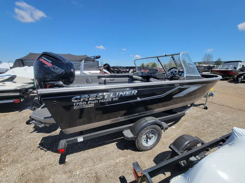 Slide: The Image of 2023 Crestliner 1750 Fish Hawk SE WT boat on trailer, outdoor display. - 4