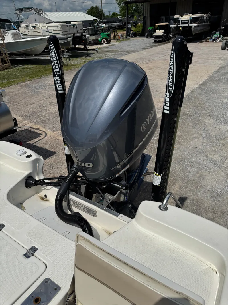 Slide: The Image of 2017 NauticStar 2200 Sport boat with Yamaha outboard motor, docked outdoors. - 10