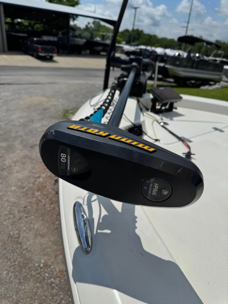 Slide: The Image of 2017 NauticStar 2200 Sport boat with trolling motor in a marina setting. - 4