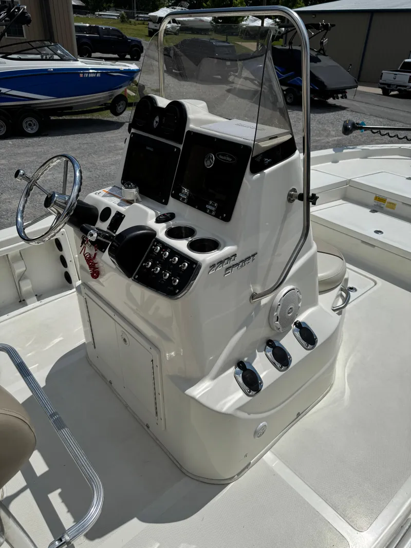 Slide: The Image of 2017 NauticStar 2200 Sport boat console with steering wheel and control panel. - 7