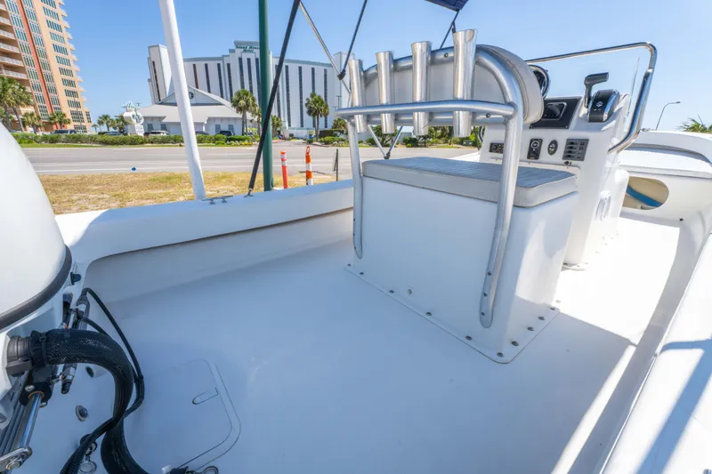 Slide: The Image of 2016 Panga 19 Niente boat interior with console and seating, cityscape in background. - 11