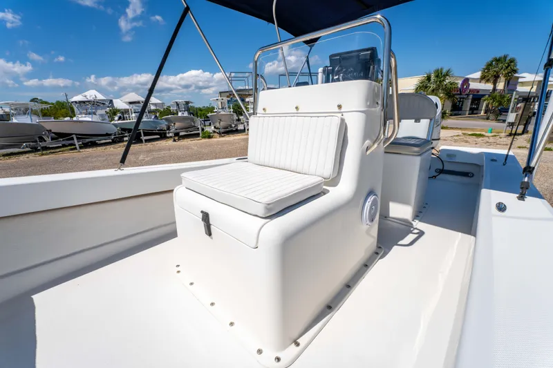 Slide: The Image of 2016 Panga 19 Niente boat interior with white seating and console under blue sky. - 14