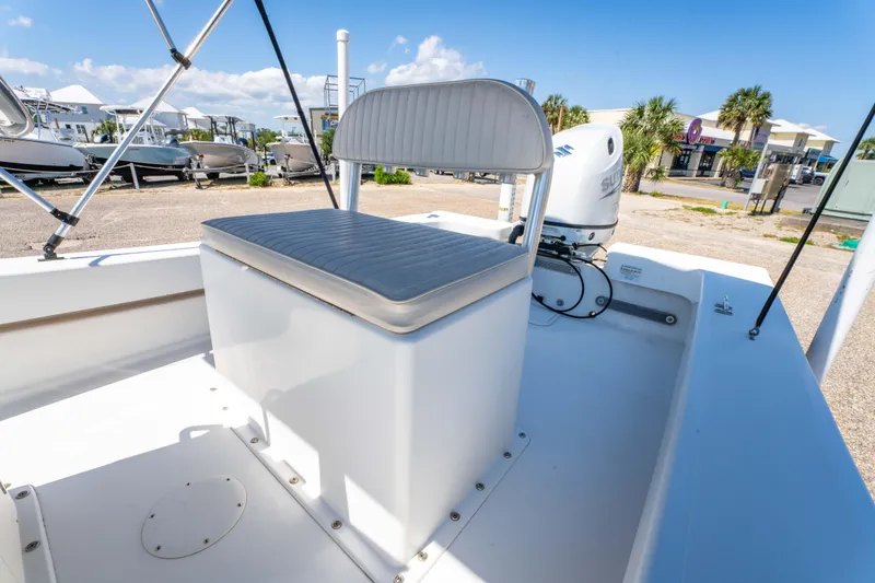 Slide: The Image of 2016 Panga 19 Niente boat interior with seating and outboard motor, under clear blue sky. - 15