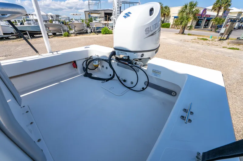 Slide: The Image of 2016 Panga 19 Niente boat with Suzuki outboard motor in a sunny outdoor setting. - 16