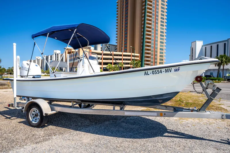 Slide: The Image of 2016 Panga 19 Niente boat on trailer, blue canopy, urban background. - 3