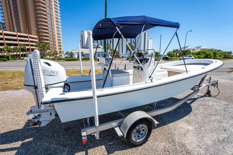 Slide: The Image of 2016 Panga 19 Niente boat on trailer with Suzuki outboard motor, parked outdoors. - 4
