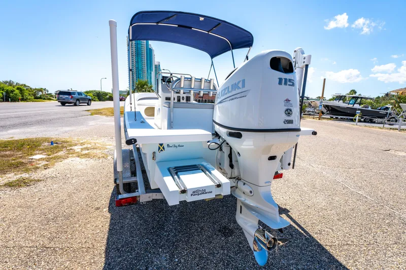 Slide: The Image of 2016 Panga 19 Niente boat with Suzuki outboard motor on a trailer, sunny day. - 6
