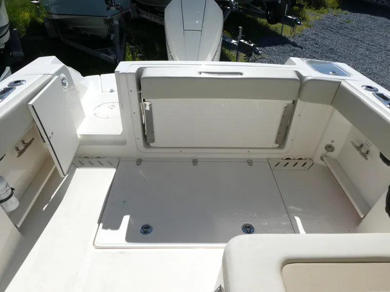 Slide: The Image of 2022 Boston Whaler 240 Vantage boat interior with seating and storage compartments. - 11