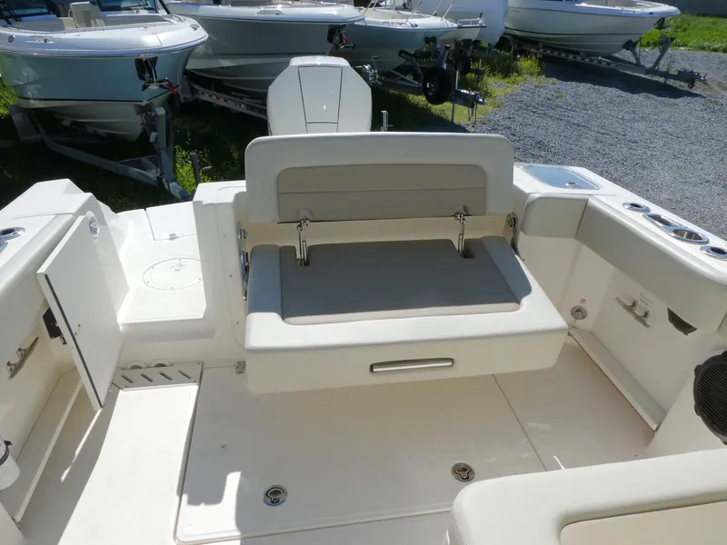 Slide: The Image of 2022 Boston Whaler 240 Vantage boat interior with seating and storage compartments. - 12