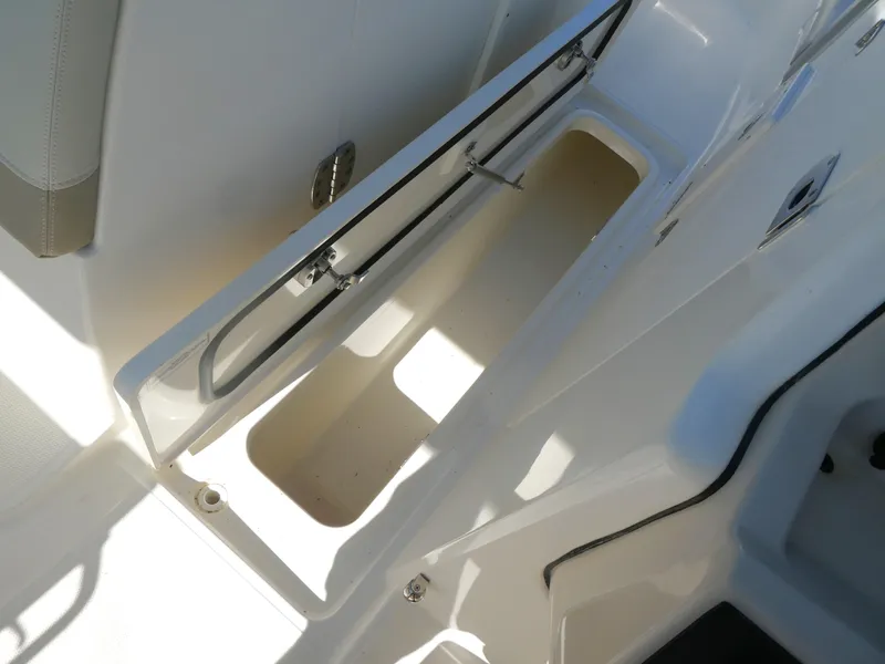 Slide: The Image of 2022 Boston Whaler 240 Vantage storage compartment, open and empty. - 14