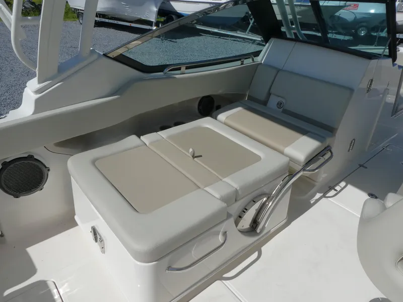 Slide: The Image of 2022 Boston Whaler 240 Vantage boat interior with cushioned seating and storage. - 9