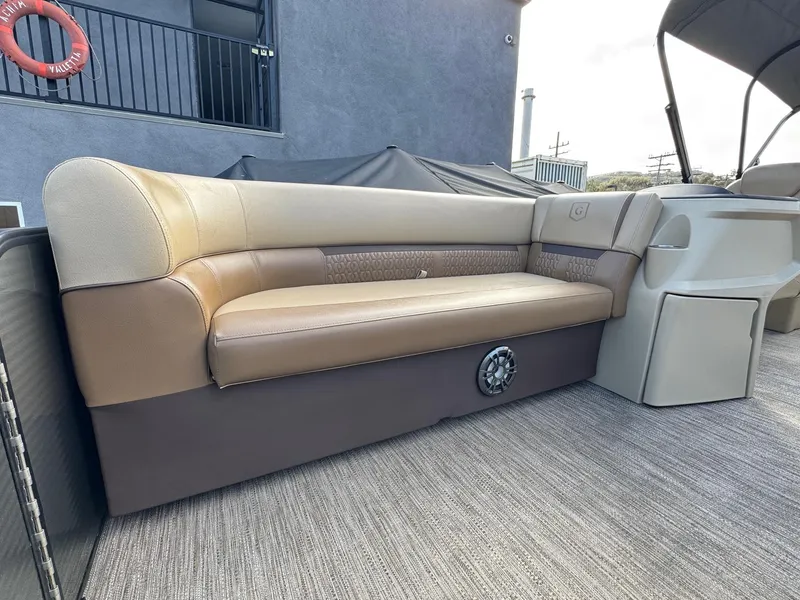 Slide: The Image of 2023 Godfrey SWEETWATER 2286 SB boat interior with beige seating and modern design. - 10