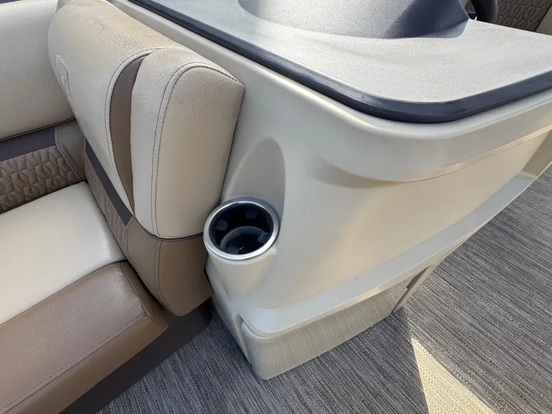 Slide: The Image of 2023 Godfrey SWEETWATER 2286 SB boat interior with beige seating and cup holder. - 13