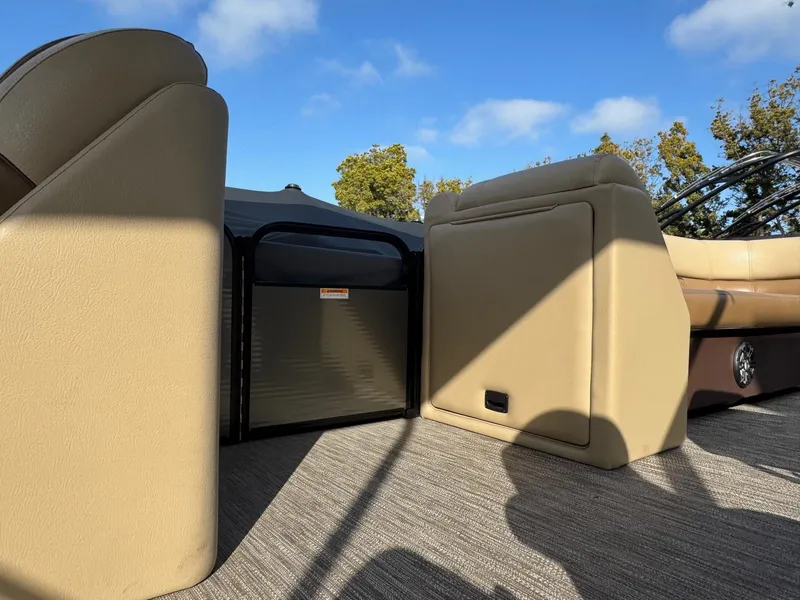 Slide: The Image of 2023 Godfrey SWEETWATER 2286 SB interior with beige seating and storage compartments. - 16