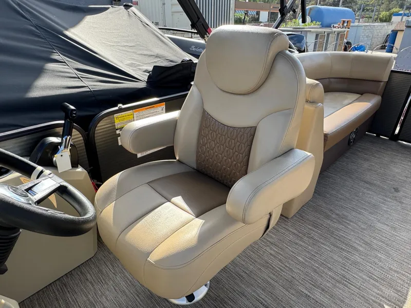 Slide: The Image of Luxurious seating on 2023 Godfrey SWEETWATER 2286 SB pontoon boat, featuring plush captain's chair. - 18