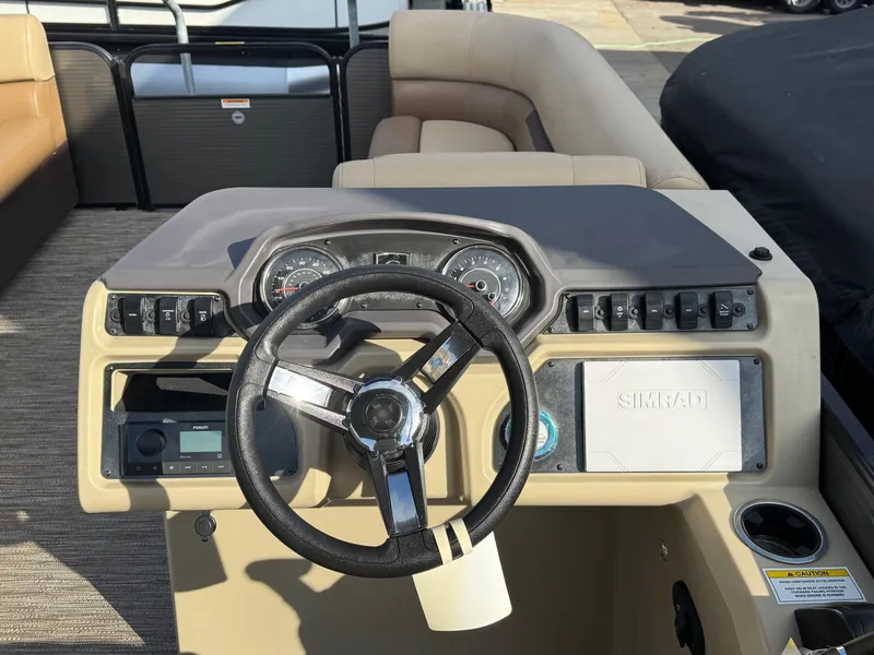 Slide: The Image of 2023 Godfrey SWEETWATER 2286 SB boat dashboard with steering wheel and controls. - 19