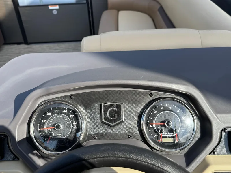 Slide: The Image of Dashboard of 2023 Godfrey SWEETWATER 2286 SB boat with gauges and steering wheel. - 23