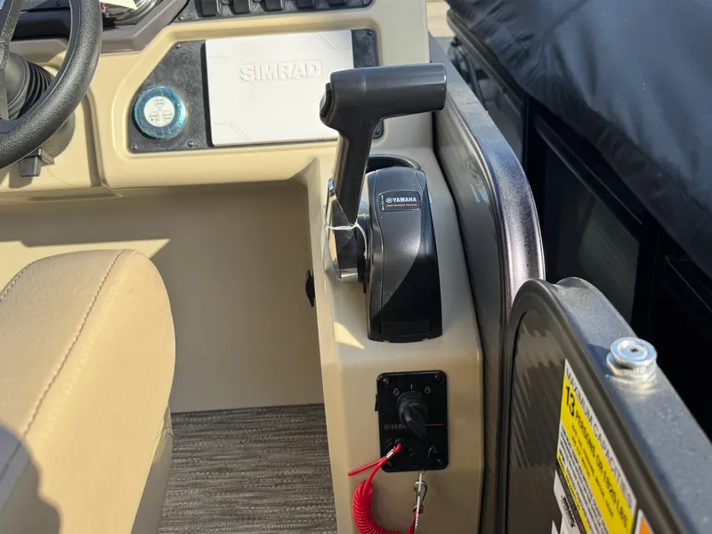 Slide: The Image of Control panel of 2023 Godfrey SWEETWATER 2286 SB boat with throttle and Simrad display. - 25