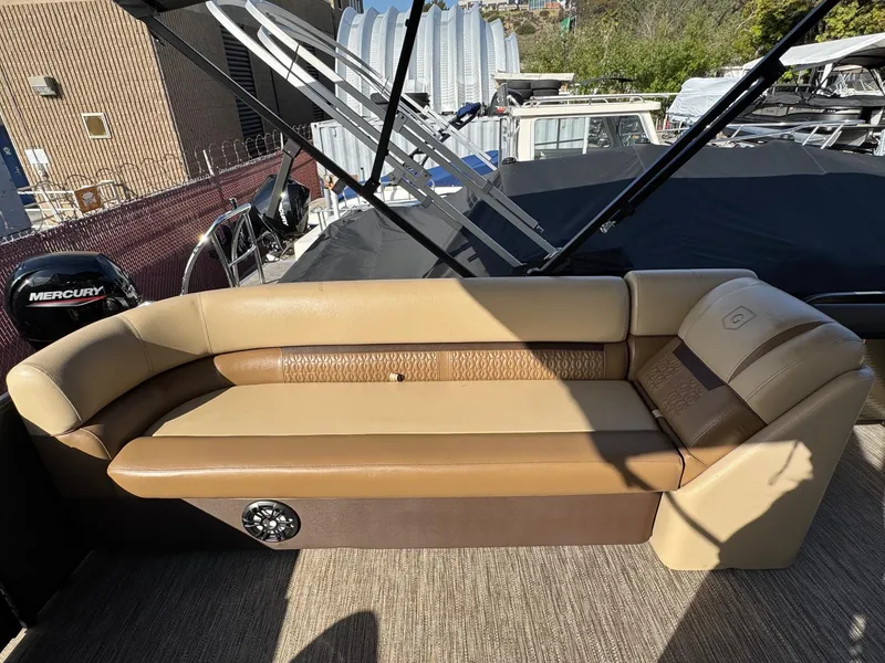Slide: The Image of 2023 Godfrey SWEETWATER 2286 SB boat interior with tan seating and Mercury engine. - 28