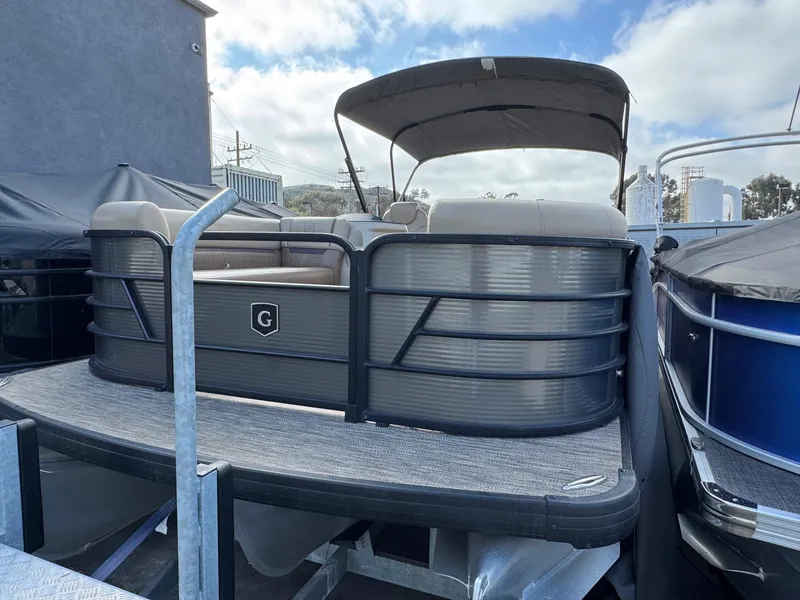 Slide: The Image of 2023 Godfrey SWEETWATER 2286 SB pontoon boat with canopy, docked outdoors. - 3