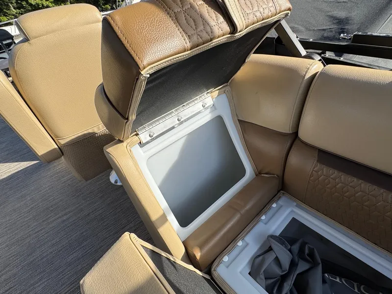 Slide: The Image of 2023 Godfrey SWEETWATER 2286 SB boat seat storage compartment, open with visible interior. - 34