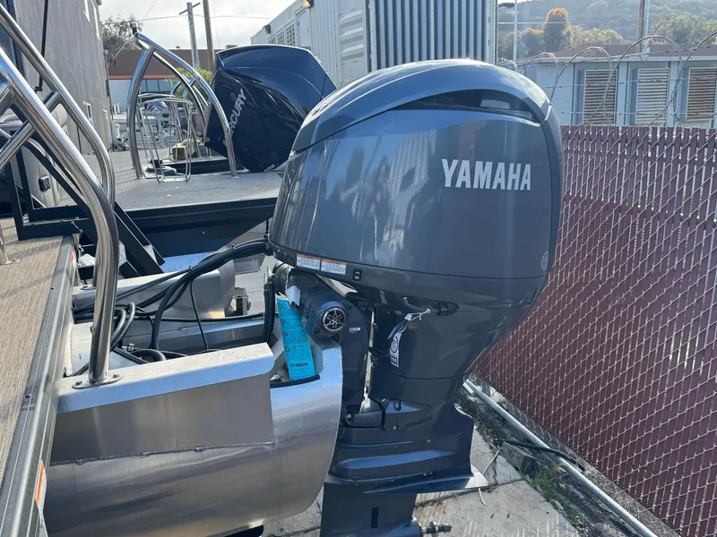 Slide: The Image of 2023 Godfrey SWEETWATER 2286 SB with Yamaha outboard motor, docked near a fence. - 38