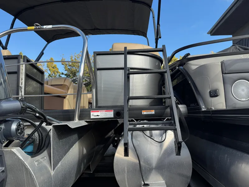 Slide: The Image of 2023 Godfrey SWEETWATER 2286 SB pontoon boat with ladder and seating, under clear blue sky. - 42