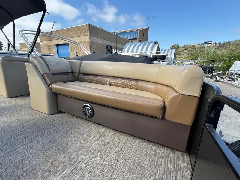 Slide: The Image of 2023 Godfrey SWEETWATER 2286 SB pontoon boat with tan seating and outdoor setting. - 7