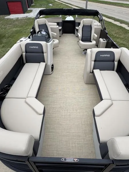 Slide: The Image of 2025 Harris Cruiser 230 pontoon boat interior with beige seating and modern design. - 4